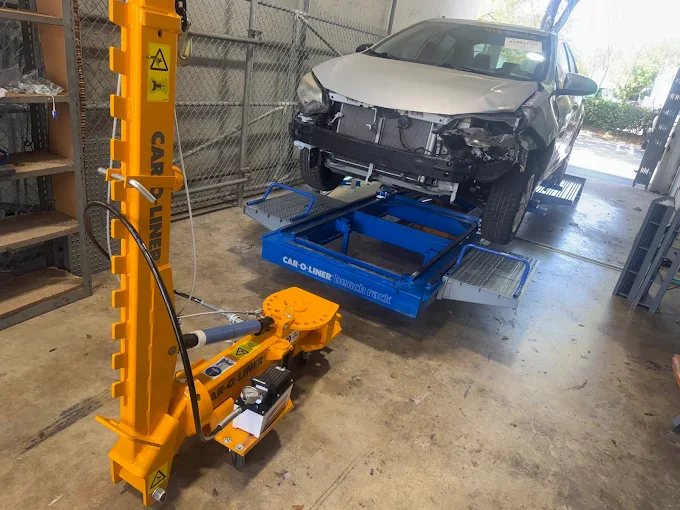 Car-O-Liner frame straightening setup with a damaged vehicle at Factory Finish