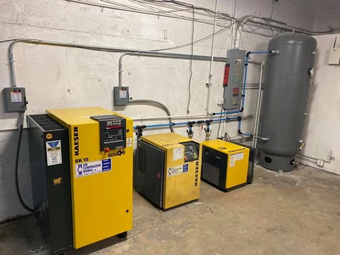Industrial Kaeser SK15 air compressor system supplying clean air to the Factory Finish paint booth