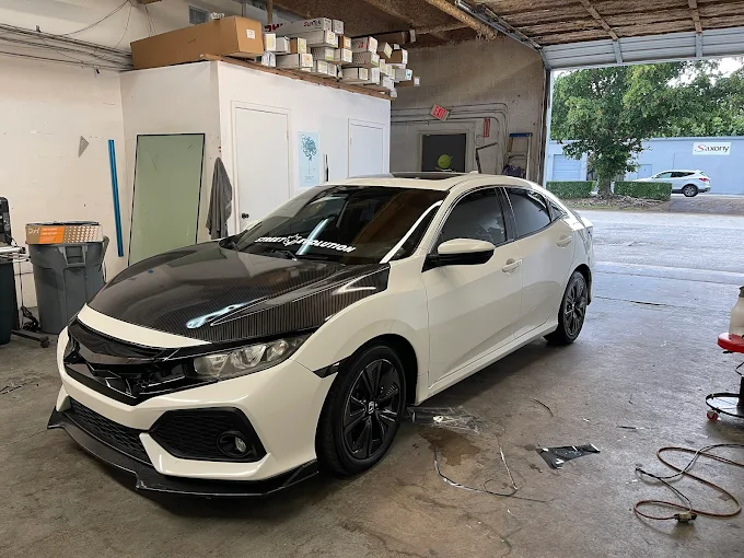 White Honda Civic hatchback with a custom carbon-fiber hood being finished at Factory Finish