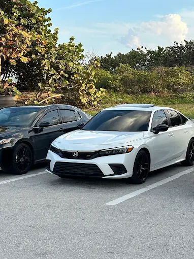 White Honda Civic Si parked at a coastal location after service by Factory Finish Paint and Body