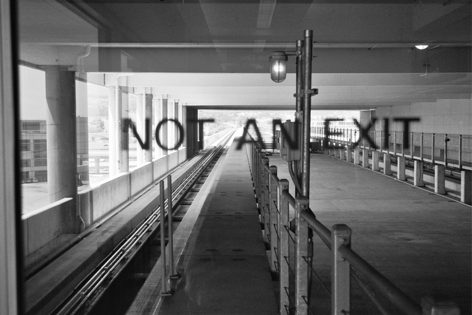 Elevated highway or transit structure with metal railings and no parking sign