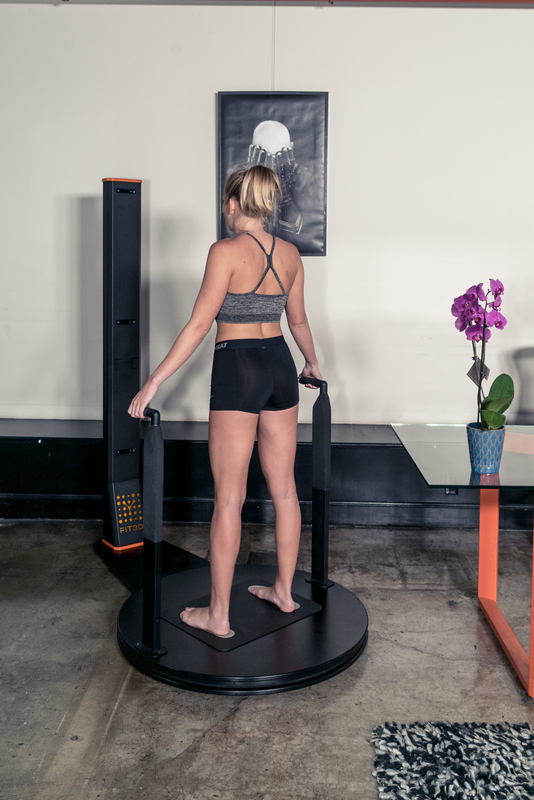 Woman using FIT3D body composition scanner