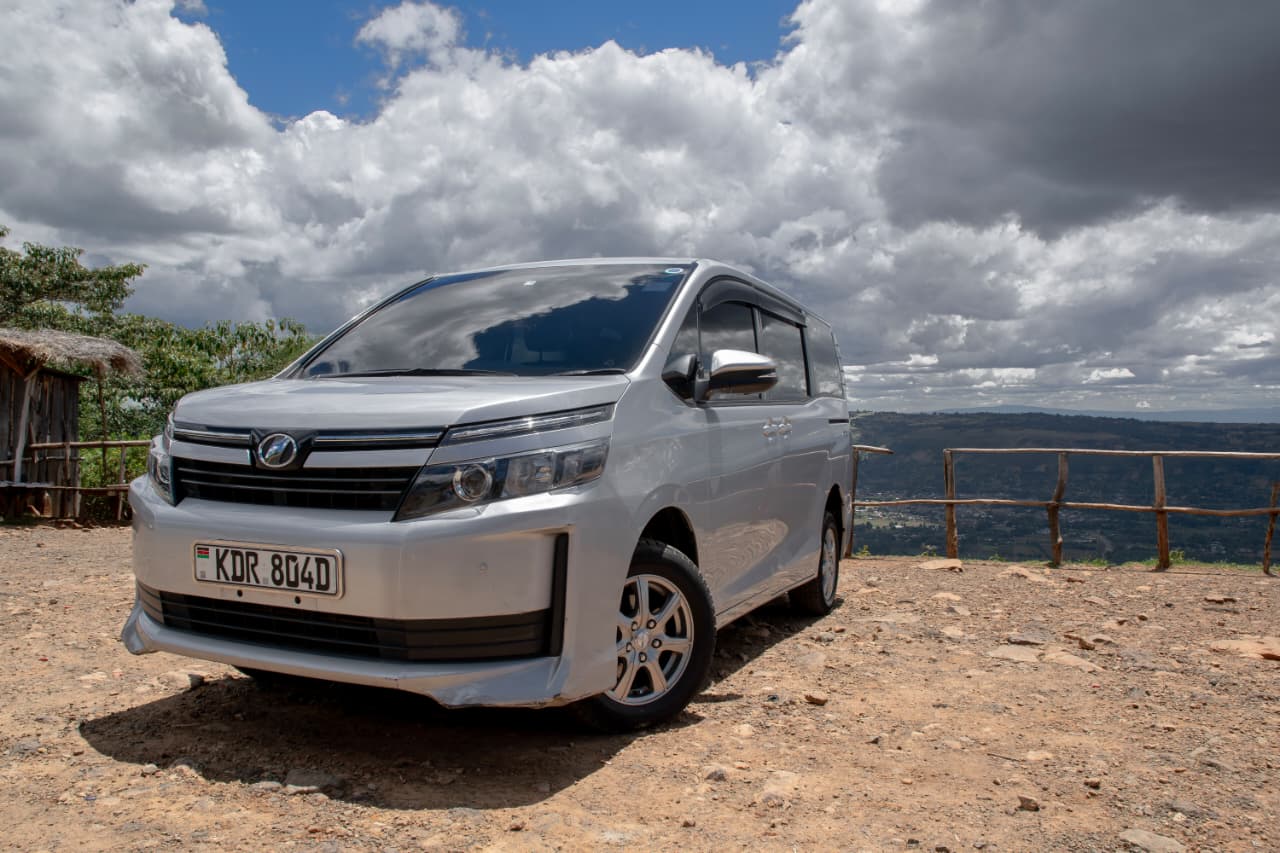 Toyota Voxy front-right exterior under a bright sky