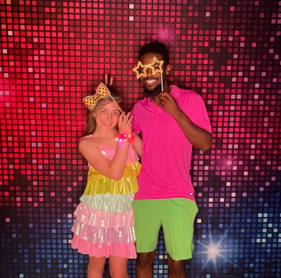Father and daughter with star glasses and pizza prop neon disco backdrop Nashville photobooth