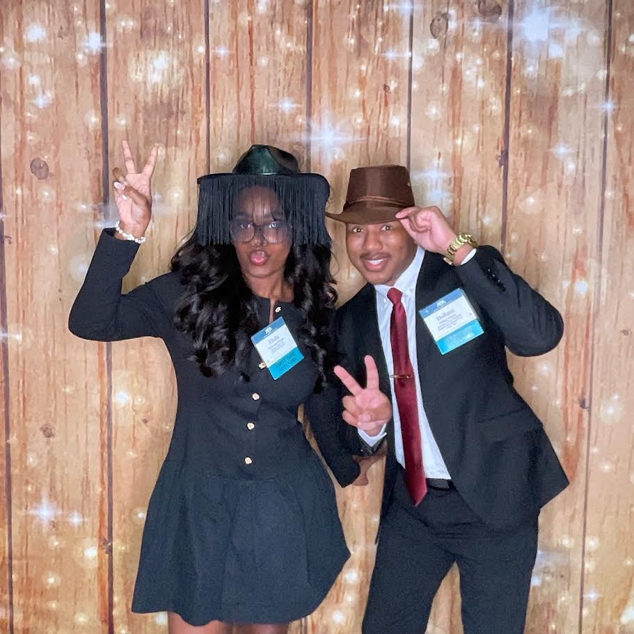 Corporate event photobooth rental Nashville professionals with props rustic backdrop