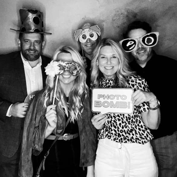 Black and white corporate party photobooth Nashville guests with fun props