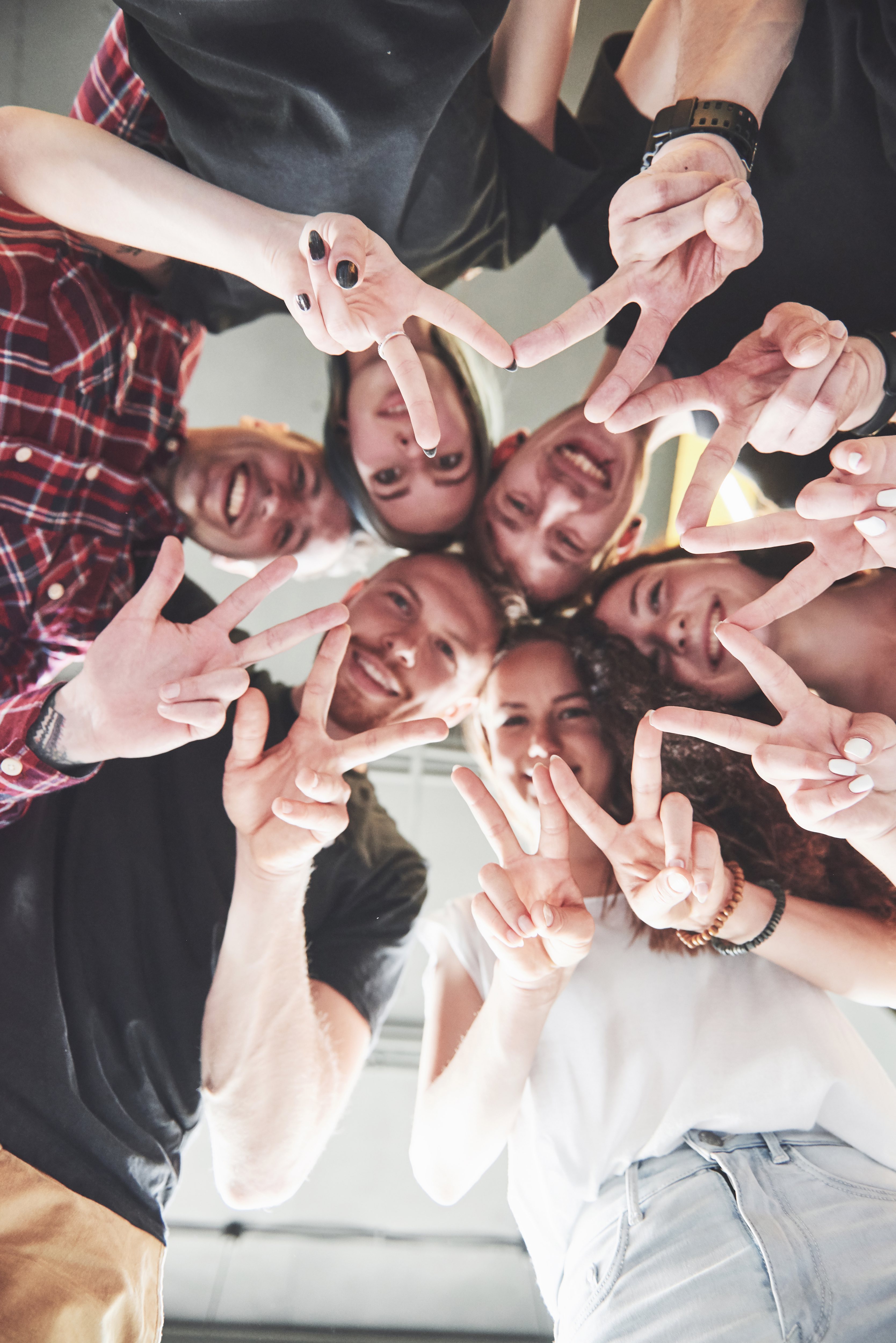 Happy group of young people with hands together