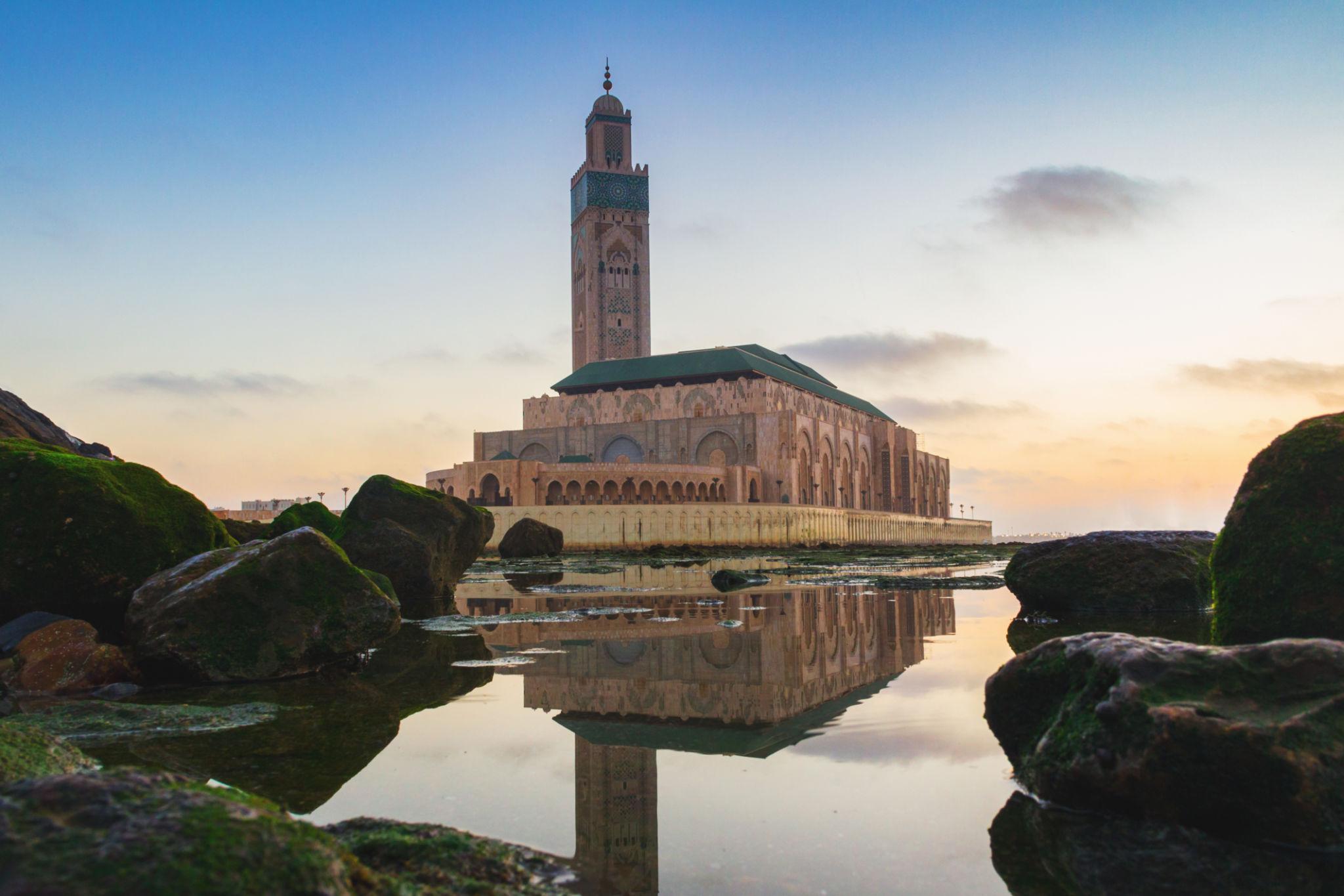 Hassan II Mosque reflected in oceanfront water at sunset
