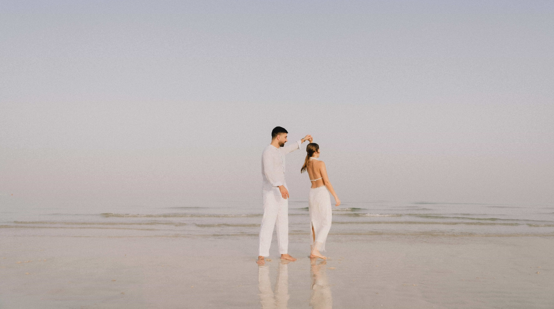 Couple walking together on a quiet beach