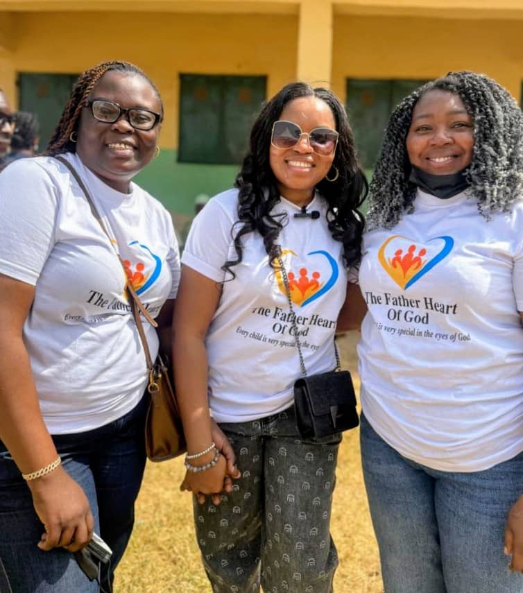 Three smiling women wearing foundation shirts at event
