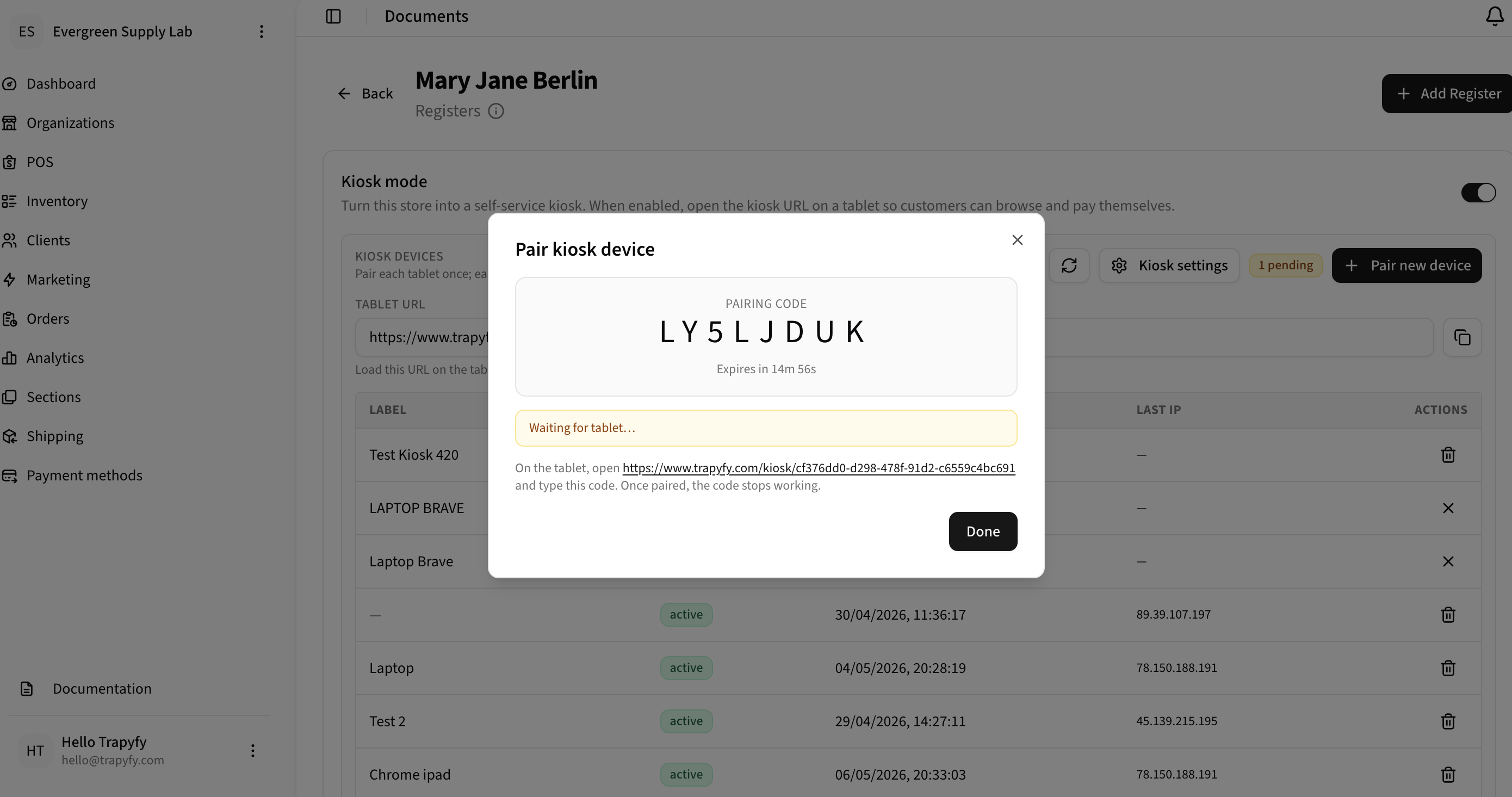 Pair kiosk device modal showing generated pairing code LY5LJDUK with 14 minute expiry and Waiting for tablet status