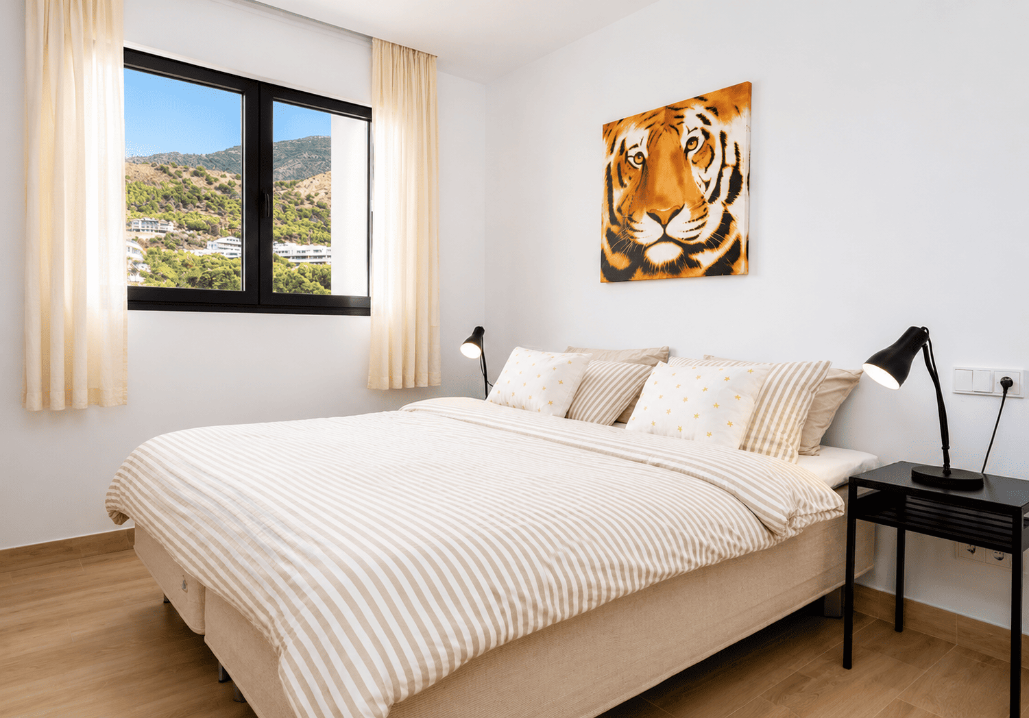 Bedroom with king bed, mountain views and tiger artwork