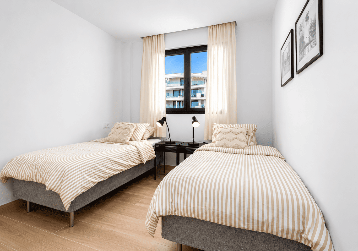 Twin bedroom with two single beds and bright window