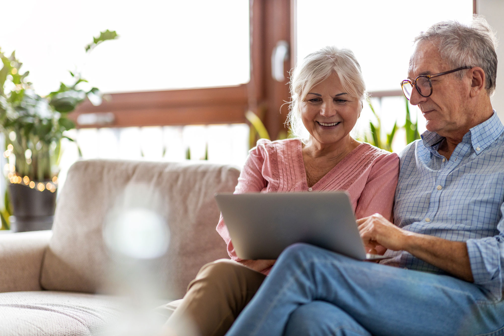 Senior couple planning together on laptop