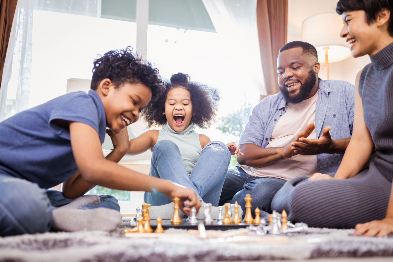 Family playing chess together, showing the joy of connection and learning