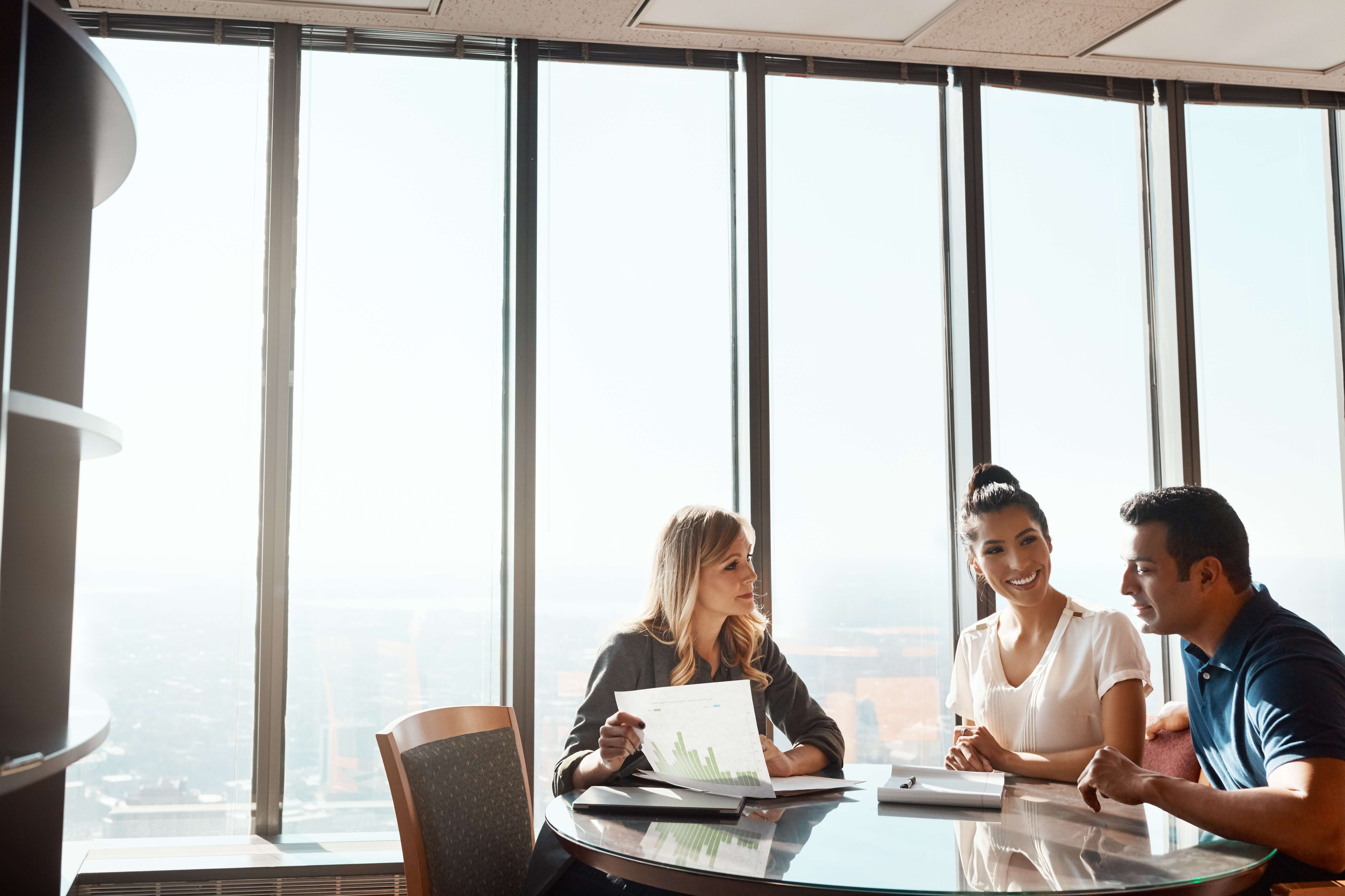 Professionals presenting and collaborating on agent selection strategy in high-rise office