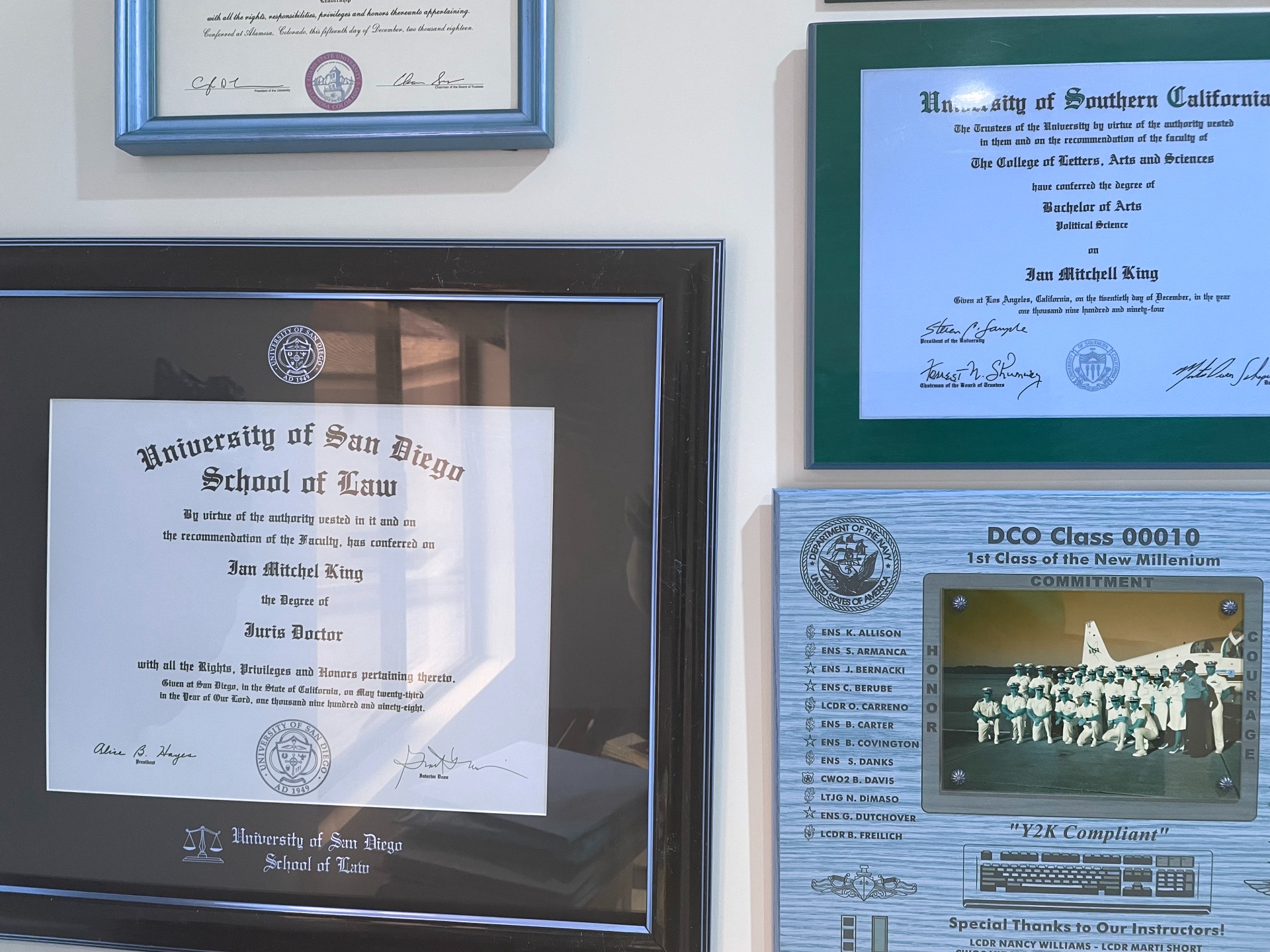 Framed diplomas including a University of Southern California Bachelor of Arts and a University of San Diego School of Law Juris Doctor.