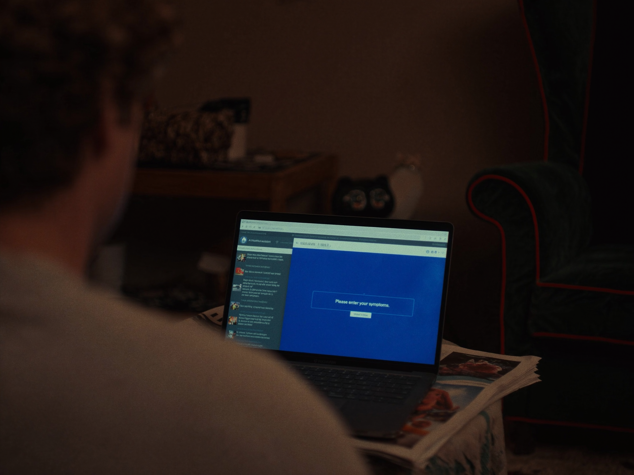 Person searching symptoms on laptop in dark room