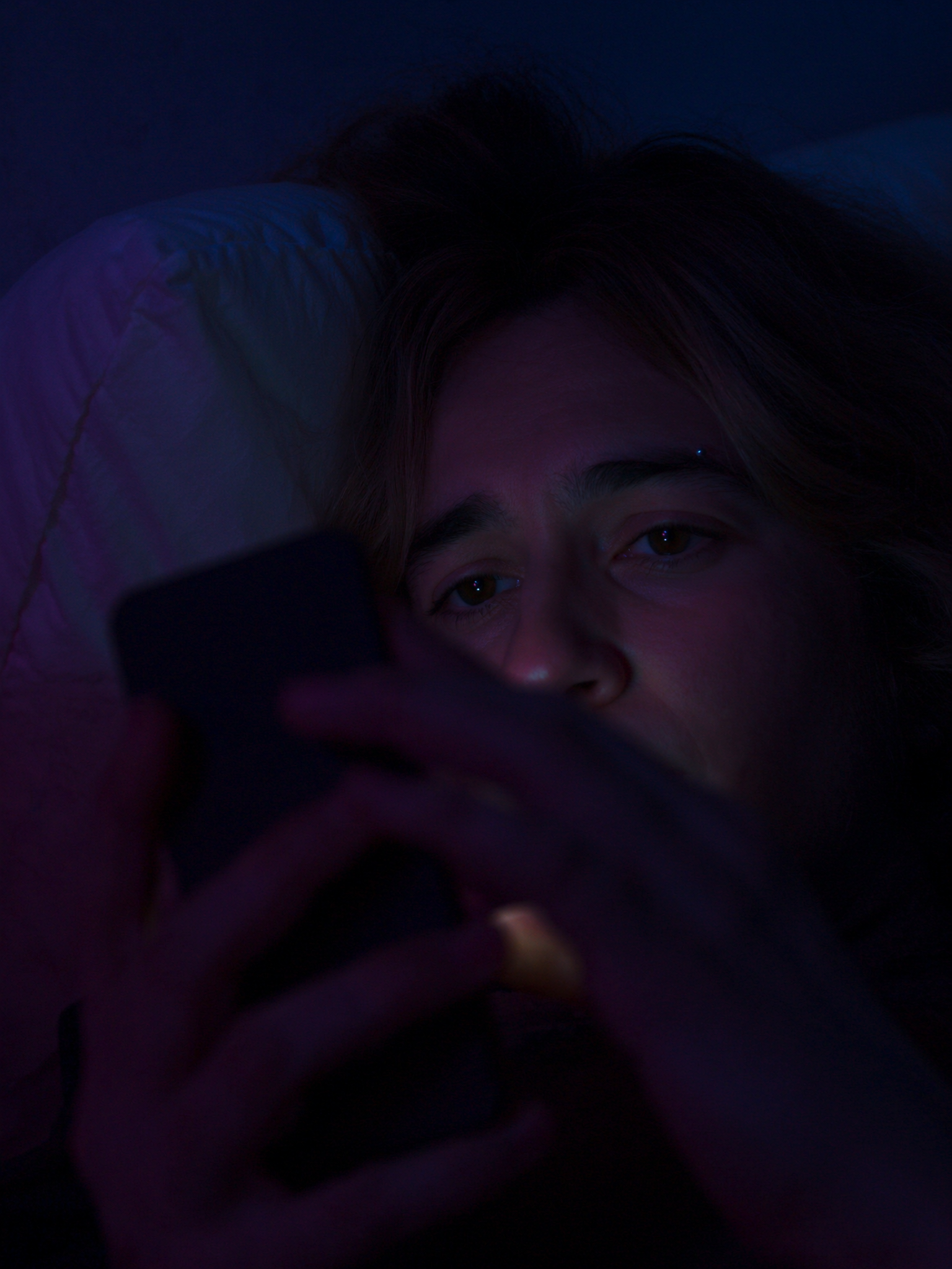 Young woman using phone at night