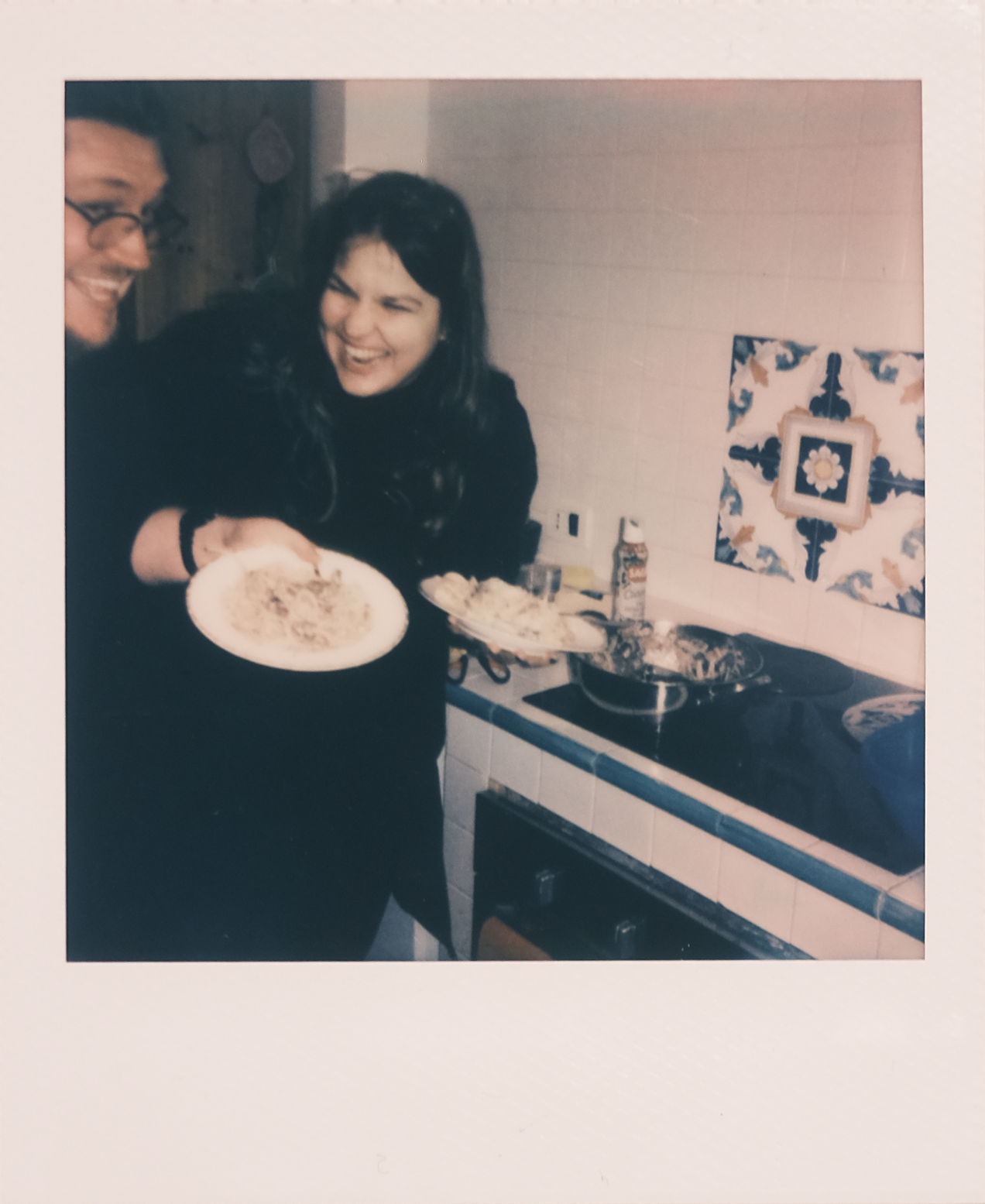 Denisa and Rogue sharing a laugh in the kitchen