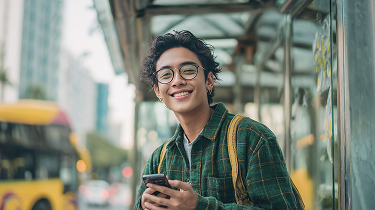 Man at bus stop with phone