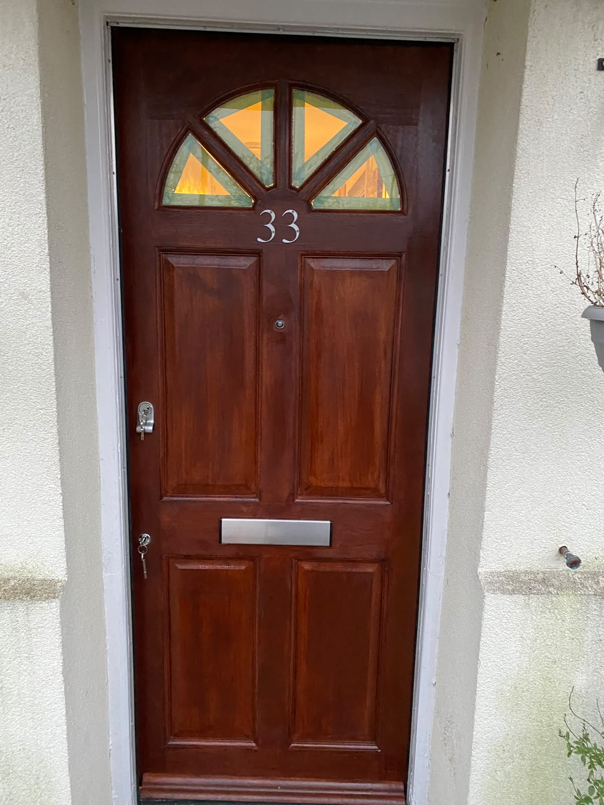 Red wooden door with yellow transom windows