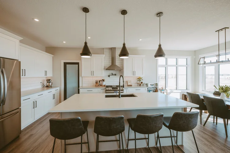 Kitchen with island and black pendant lights
