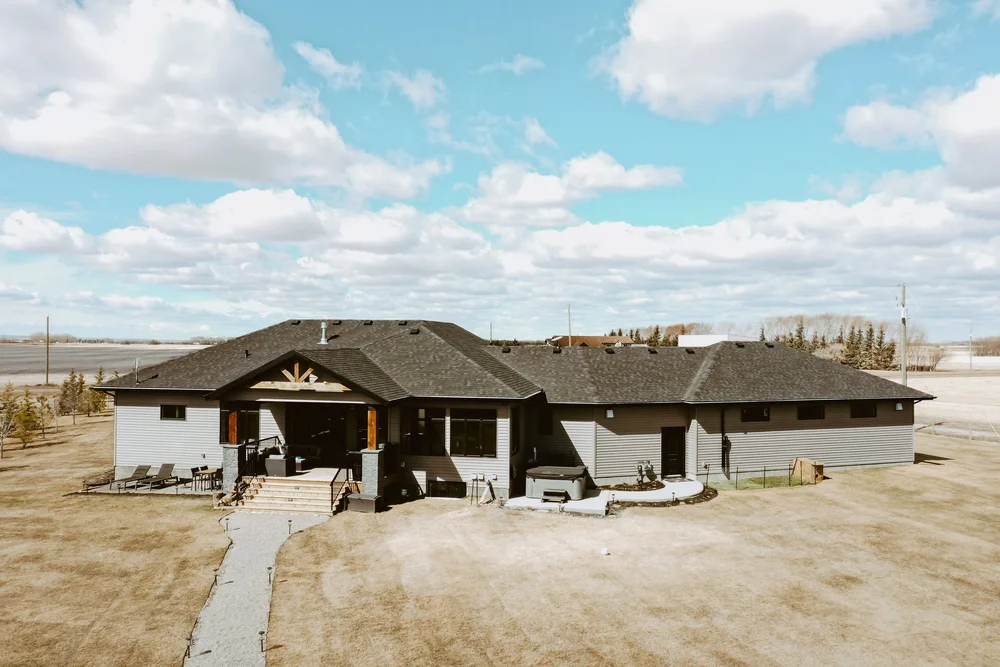 Rear exterior with covered deck and hot tub
