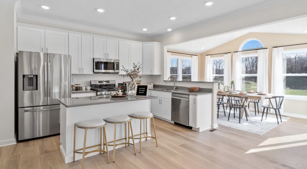 Modern white open-plan kitchen with gray counters