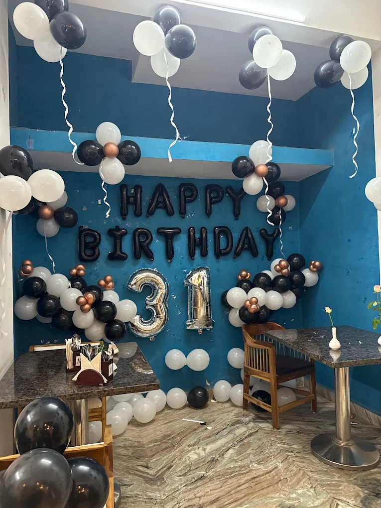 31st Birthday celebration with elegant black, white and gold balloon decorations