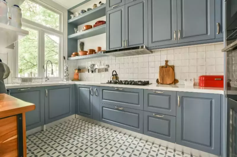 Blue-gray shaker kitchen with patterned tile floor and open shelving — Bethesda