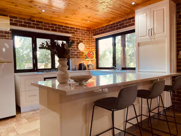 Modern kitchen with timber ceiling and island bench