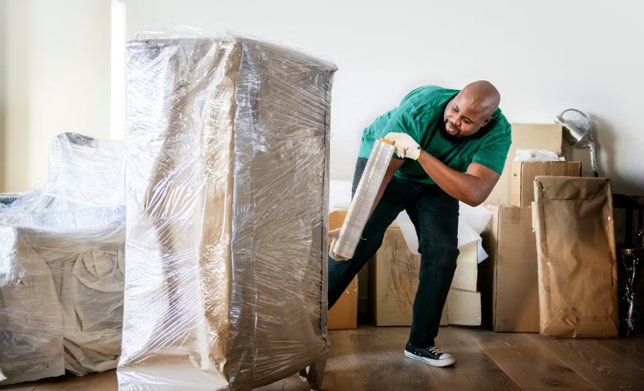 Professional mover wrapping furniture