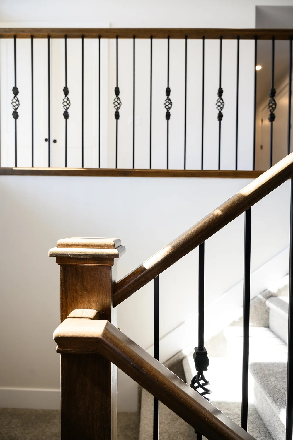 Staircase with oak railing and iron spindles