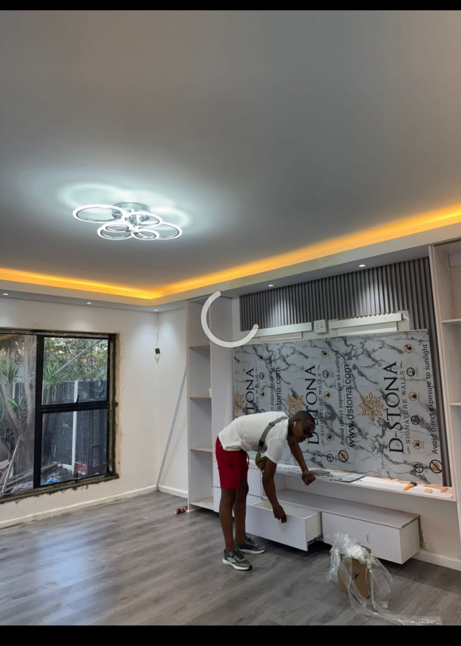 Living room media wall with installer at work