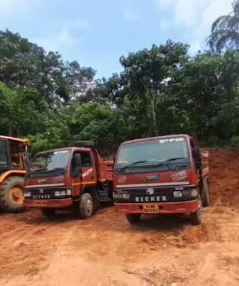 Tipper trucks and JCB ready for construction material delivery in Kannur
