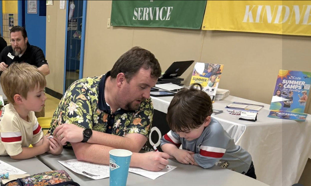 Dad helping kids with activities at a school event