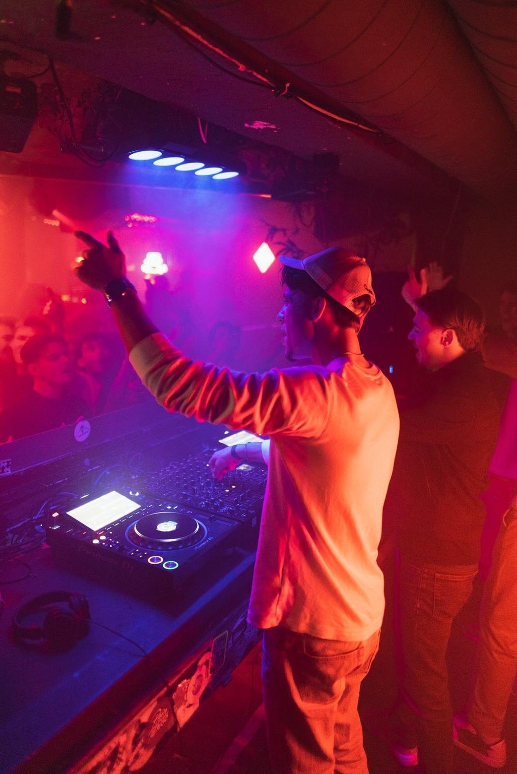 DJ performing with arm raised