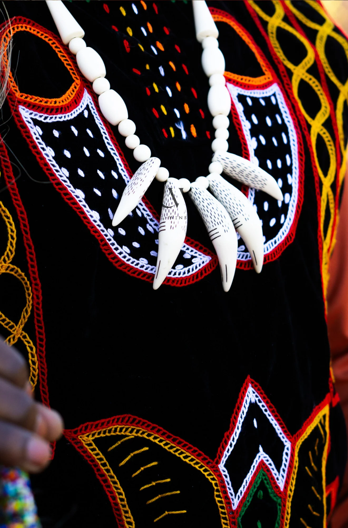 Florven embroidered fabric and shell necklace detail