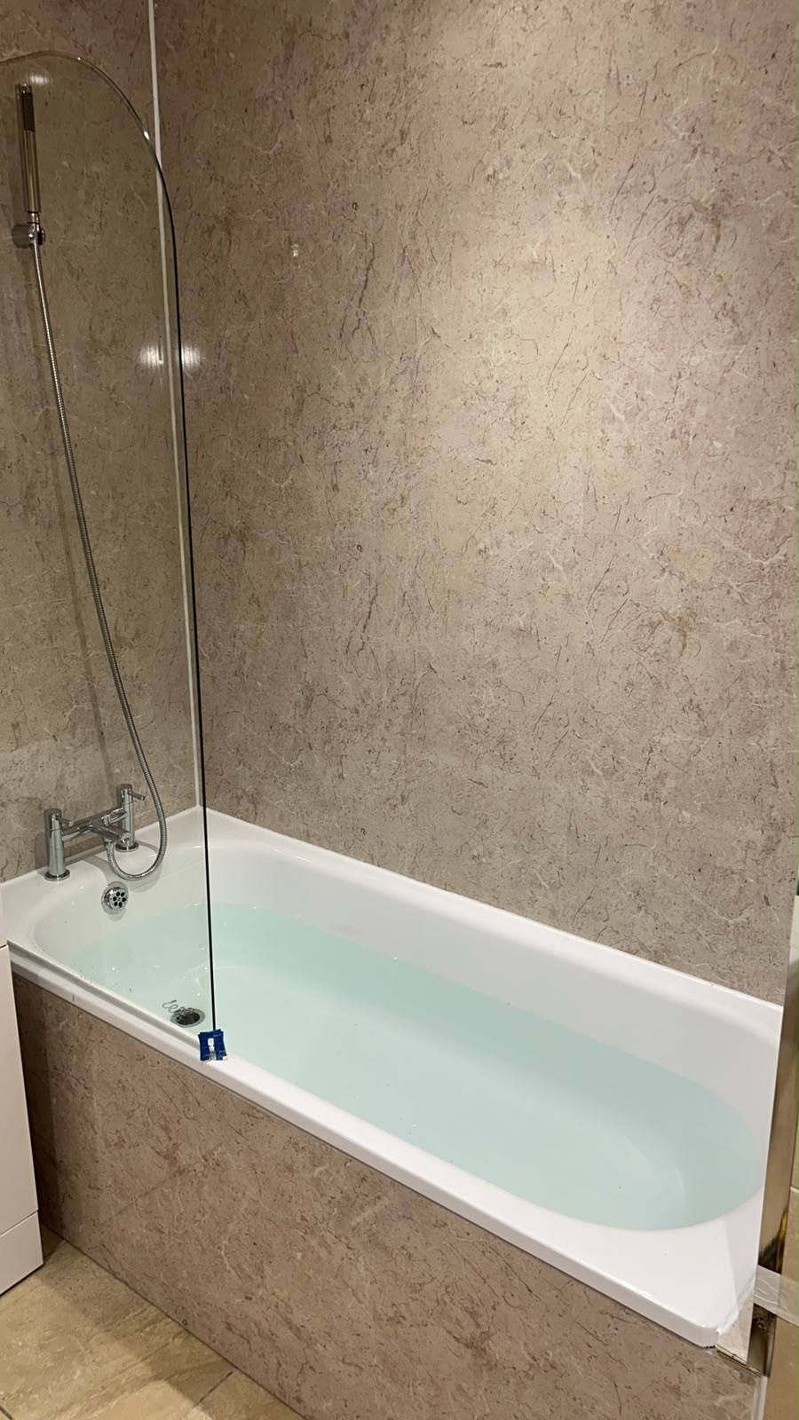 Marble-effect shower with glass enclosure