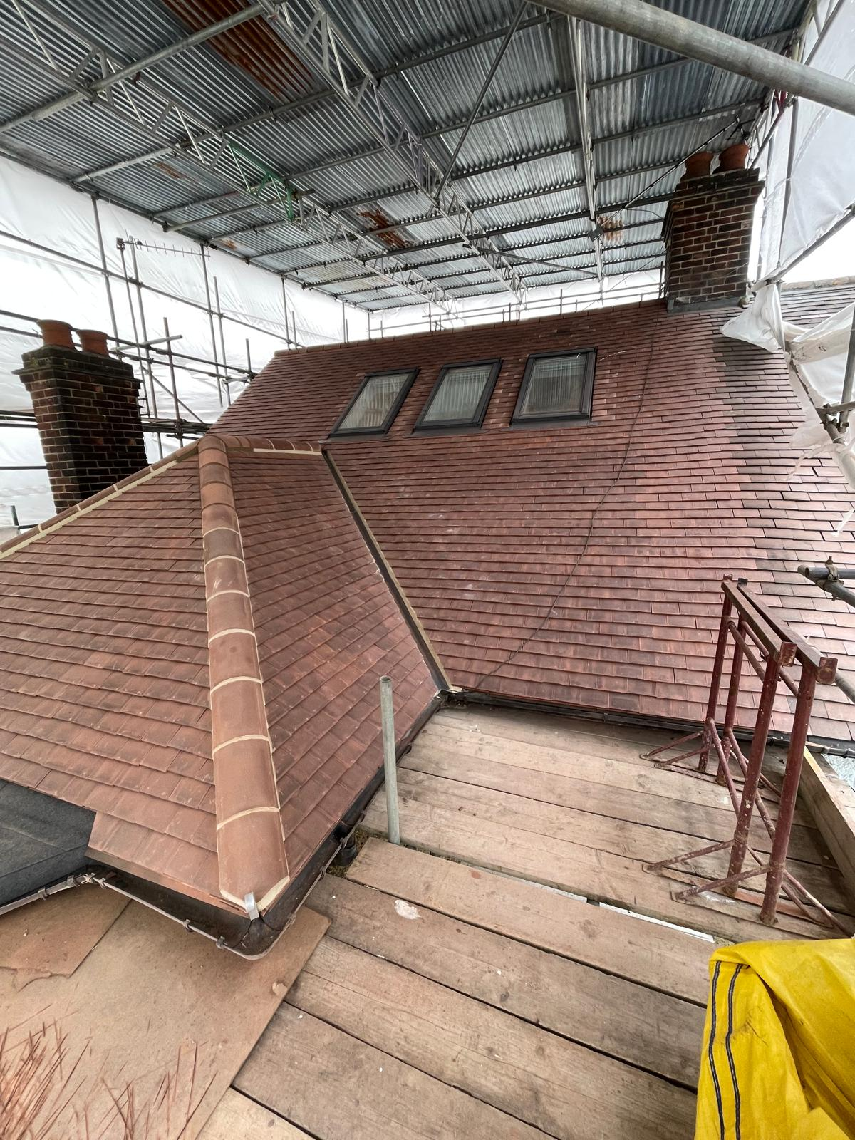 New clay tile roof installation in progress under scaffolding by M.W. Beal & Son in Essex