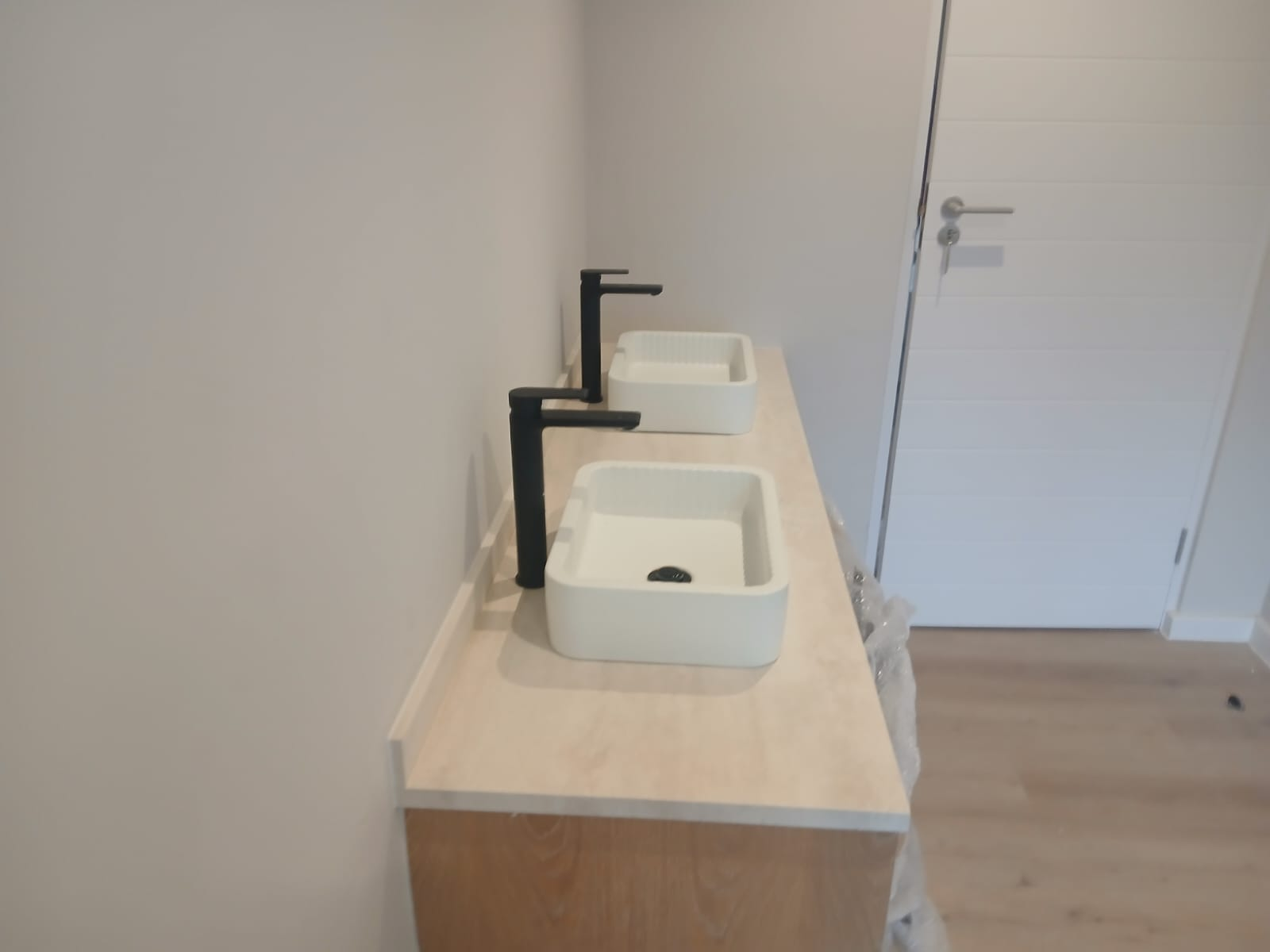 Double vanity with matte black taps