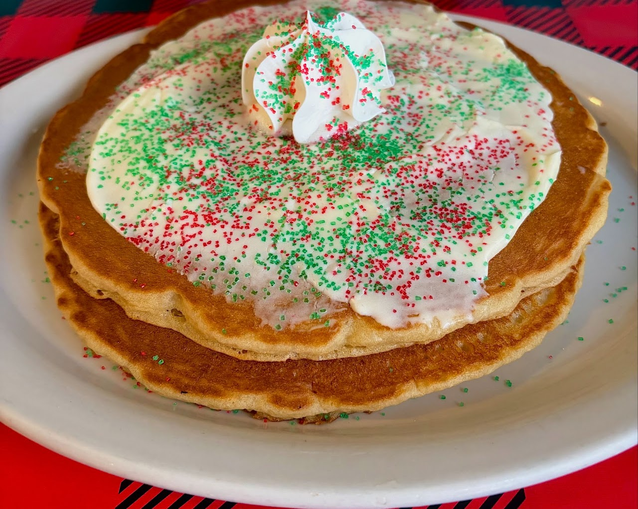 Pancakes with whipped cream and holiday sprinkles