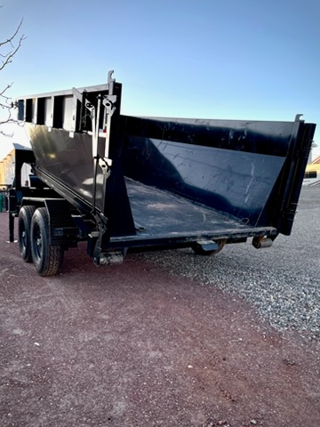 Rear close-up of roll-off dumpster container showing open top and interior liner