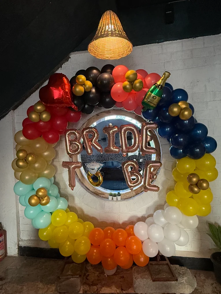 Bride to Be celebration with rainbow balloon arch and decorations
