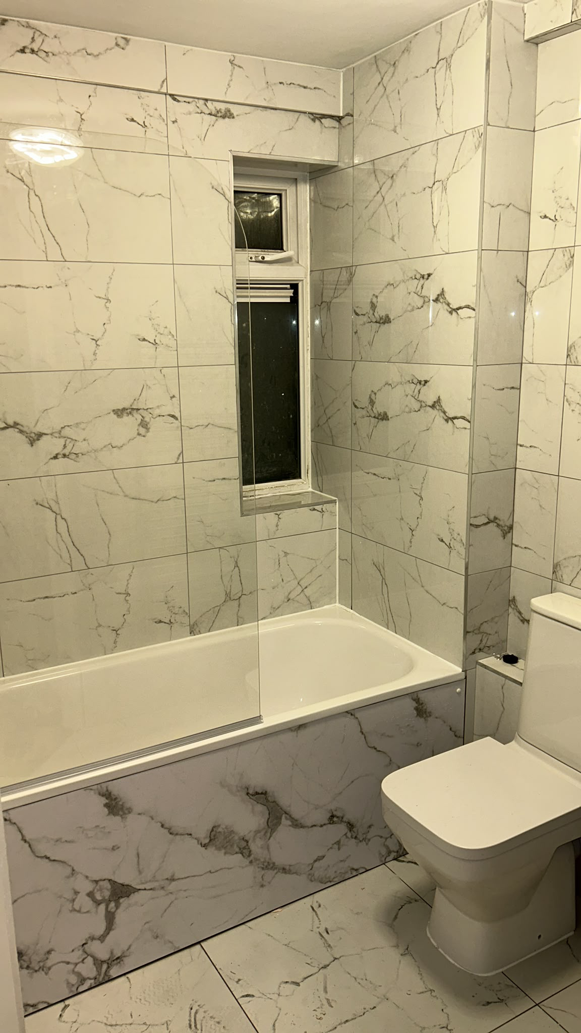 Luxurious marble-tiled bathroom with Calcutta marble effect