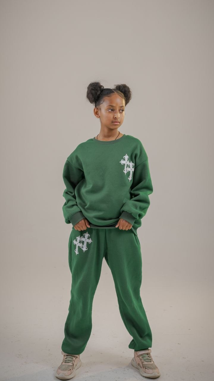 Child model wearing a green tracksuit