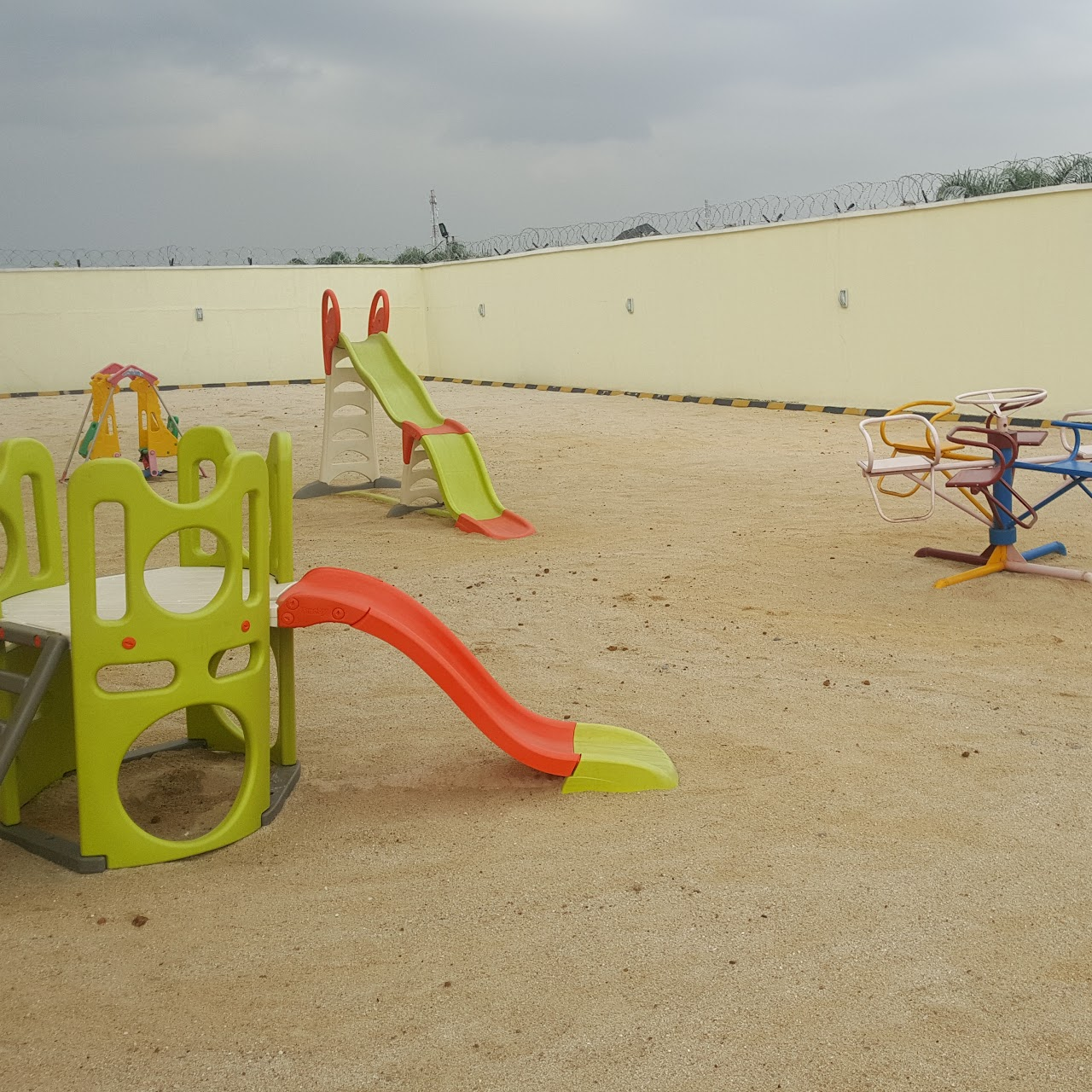 Outdoor playground with slides and a merry-go-round