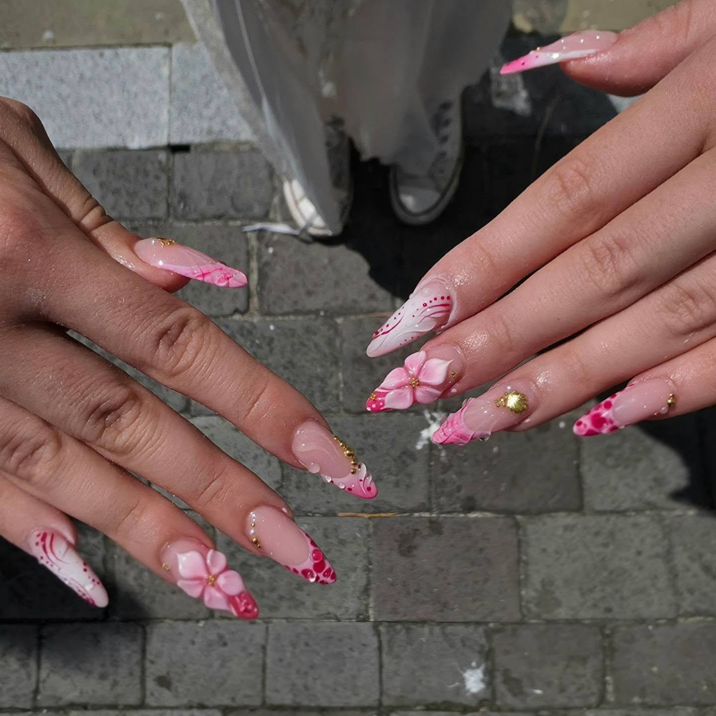 Pink floral nail art with sparkles