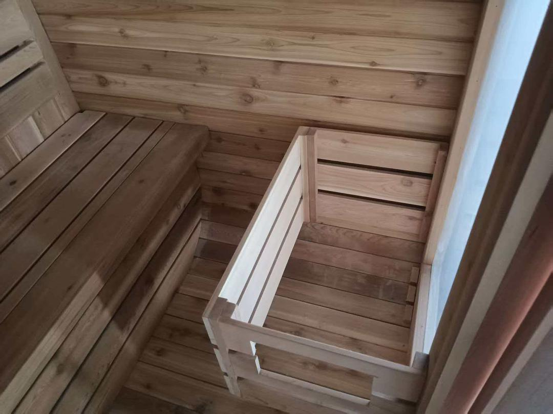 Detail of the completed cedar interior fit out, including bench construction and heater guard